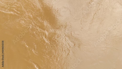 Abstract aerial view of muddy river surface with swirling water patterns and unique earthy texture