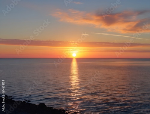 A stunning sunset casting its glow over the tranquil waters of the ocean