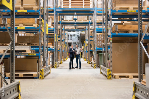 Businessmen standing and planning in warehouse