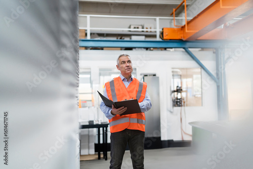 Wallpaper Mural Engineer preparing checklist near machinery in factory Torontodigital.ca