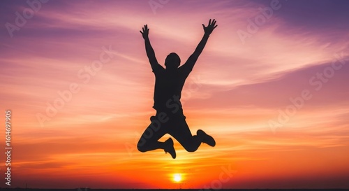 Wallpaper Mural Joyful person jumping with arms raised high against a vibrant sunset sky silhouette Torontodigital.ca