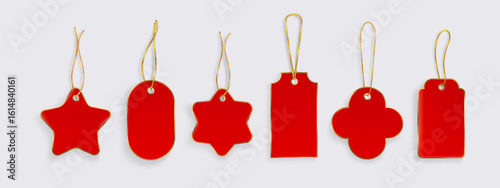 Red gift tags with gold string hanging loops - festive shapes of star and cross, oval and rectangle designs. Blank price labels for Christmas presents, retail merchandise or holiday decorations.