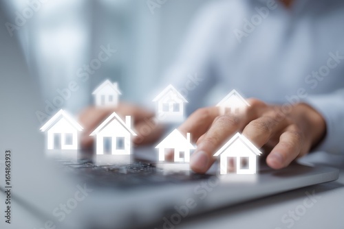 Person's hands hover over laptop keyboard; small house icons appear above