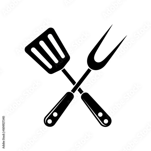 A spatula and fork are crossed on a plain white background, isolated on white background
