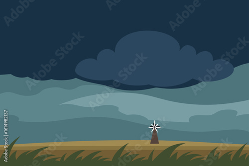 Stormy sky over a lone windmill in a field