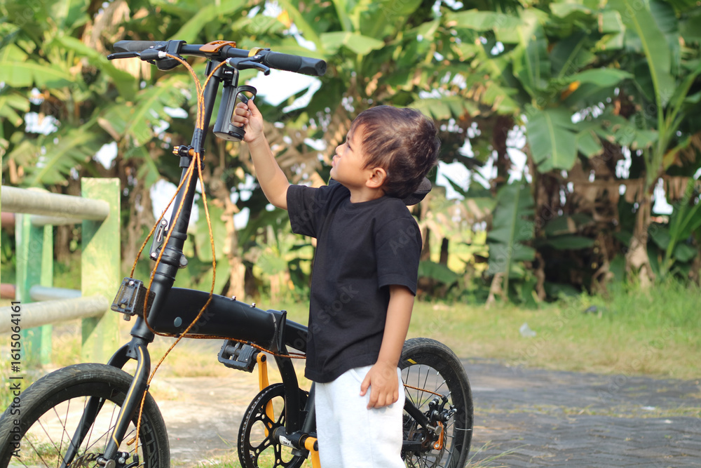 Obraz premium happy african american boy riding bike in park in summer