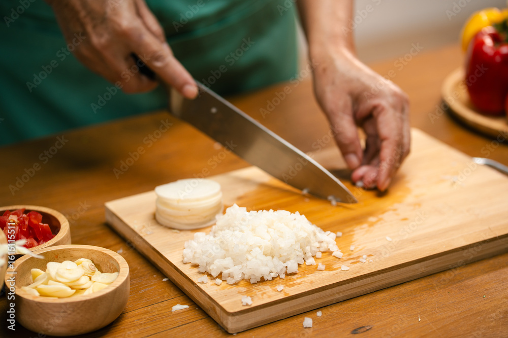 Hands slicing Radish on a wooden board in the kitchen, preparing to cook. Hands slicing Radish on a wooden board in the kitchen, preparing to cook.