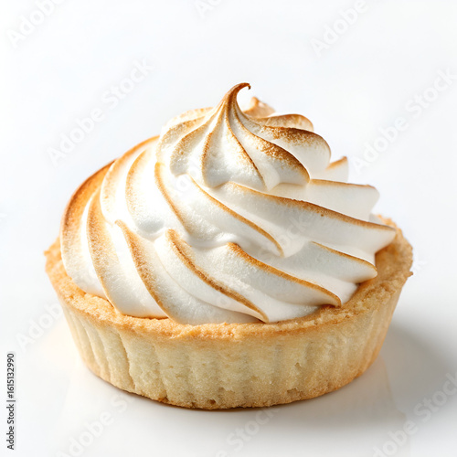 A single lemon meringue tart with toasted meringue swirls on a white surface in a close up shot