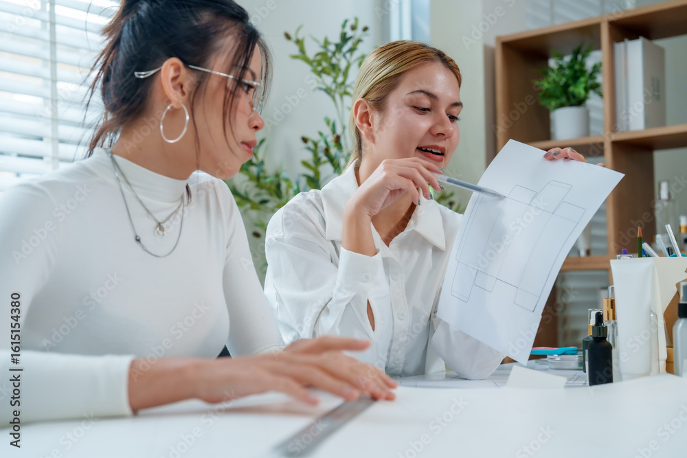 Fototapeta premium Creative professionals engage in market research and product development, focusing on cosmetic packaging design to enhance visual appeal and functionality