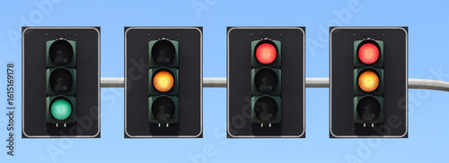 Traffic light sequence: green, yellow, red and red + yellow light with the sky as background