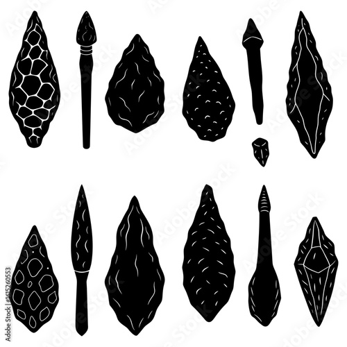 Collection of various stone age tools and weapons including hand axes and spear points in black and white