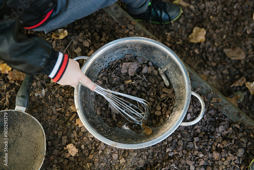 Wallpaper Mural Close up shot of dirt and stones in a silver pale being mixed with an egg beater Torontodigital.ca