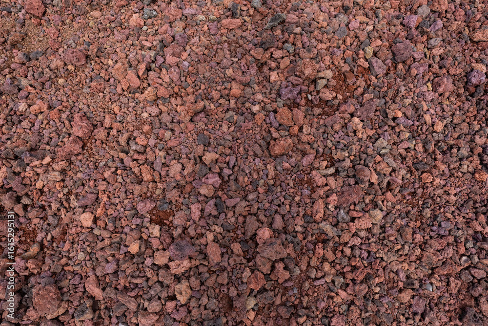 Naklejka premium Looking down at soil with red color.