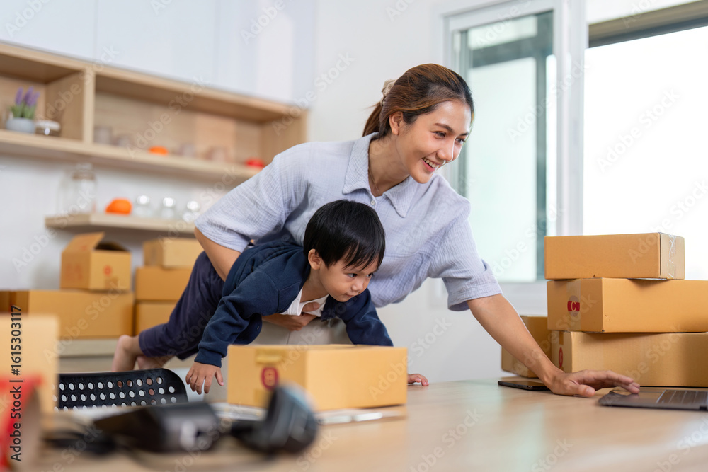 Playful Learning. Mother helping child explore laptop while balancing on packages. Playful Learning. Mother helping child explore laptop while balancing on packages.