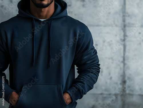 Close-up of a dark navy blue hoodie with hands in pockets on a man