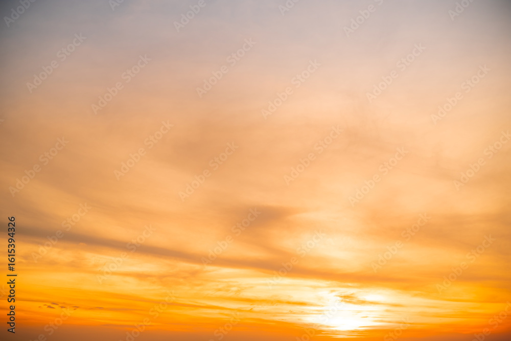 Obraz premium Beautiful , luxury soft gradient orange gold clouds and sunlight on the blue sky perfect for the background, take in evening,Twilight, Large size, high definition landscape photo