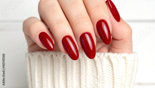 Close-up of manicured hand with red nails