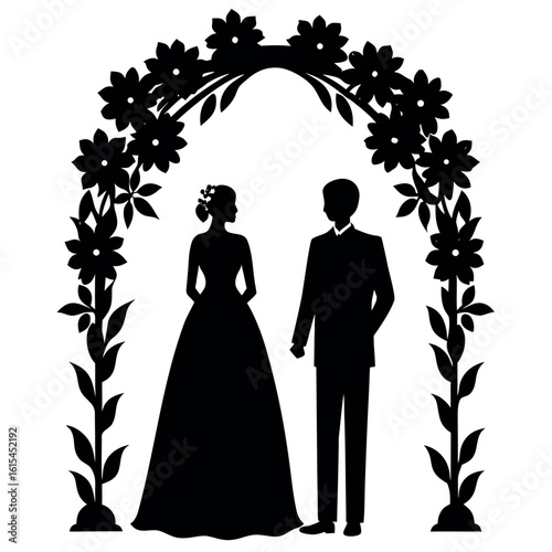 Silhouette of a bride and groom under a floral wedding arch