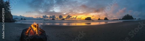 A Cozy Beach Campfire Glows Against a Dramatic Pacific Sunset with Sea Stacks