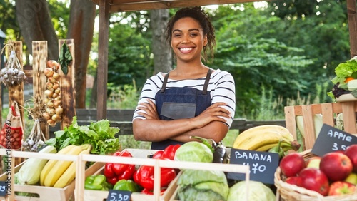 Wallpaper Mural Camera moving to pretty young smiling African American woman farmer in apron selling farm food at market outdoor. Beautiful positive happy female sell organic fresh vegetables and fruits Torontodigital.ca
