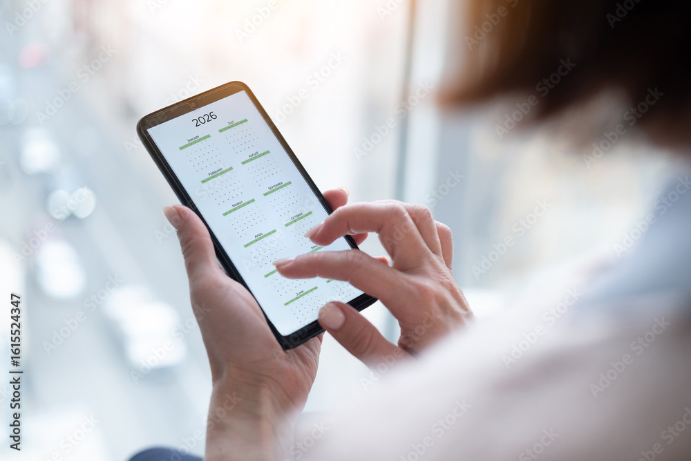custom made wallpaper toronto digitalClose-Up Of A Woman Holding A Smartphone Displaying The 2026 Calendar