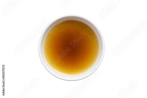 a cup of tea with a brown liquid