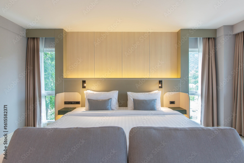 Fototapeta premium bedroom with two queen-sized beds, contemporary decor.