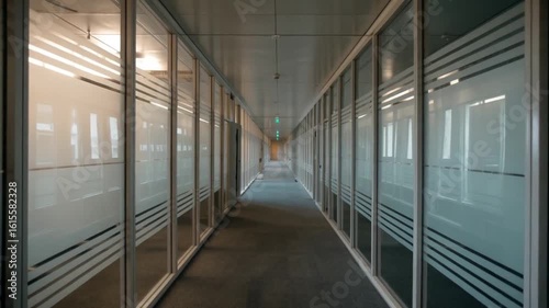 Modern office hallway with frosted glass partitions and subtle lighting, creating a professional and sleek atmosphere for business.