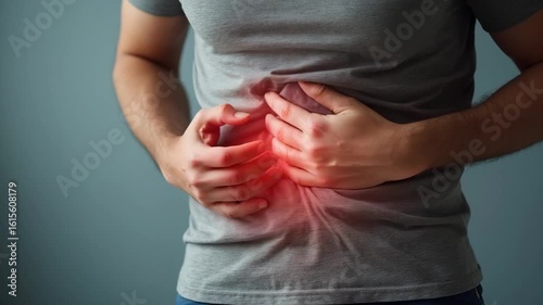 Man suffering from intolerance or food poisoning, stomach ache, abdominal pain, colon problems, gastritis, diarrhea or inflammation. Patient's hand on the belly or abdomen.