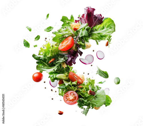 Freshly tossed salad ingredients floating against a dramatic transparent background