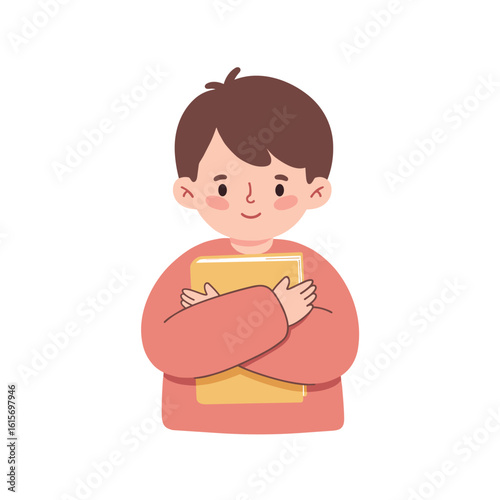 Young boy smiling while holding a book close to his chest  
