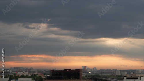 Time lapse. Panorama of evening summer city after rain. bright sunset horizon is again closed by approaching clouds