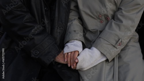 The hands of loving newlyweds warm each other with wedding rings