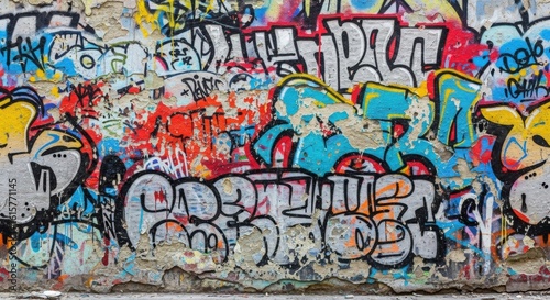 Colorful graffiti art covers a weathered urban wall, with layers of tags, letters, and paint creating a vibrant, textured street scene.