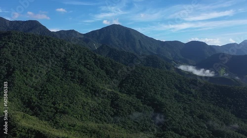 Aerial view of a mountainous and preserved region of the Atlantic Forest, a tropical rainforest in Rio de Janeiro, Brazil. The beauty and biodiversity are the highlights.