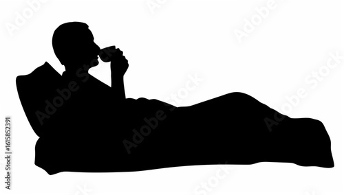 Silhouette of person reclining in bed with a pillow and blanket while drinking from a cup or mug item