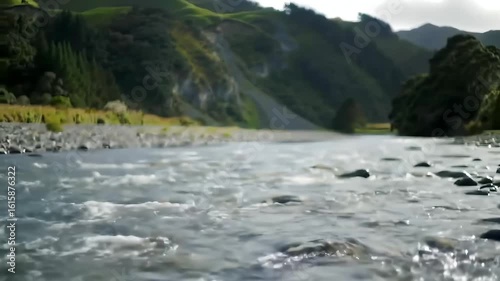 River flows, green hills background