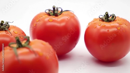 Juicy red tomatoes on white, close-up