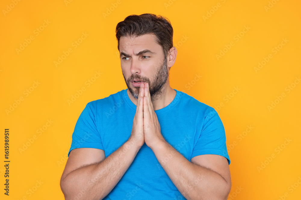 A man is praying to God. Calm spiritual handsome man praying. Serious peaceful man with joining hands praying. Belief concept. Man praying. Male pray. A man is praying to God. Calm spiritual handsome man praying. Serious peaceful man with joining hands praying. Belief concept. Man praying. Male pray.