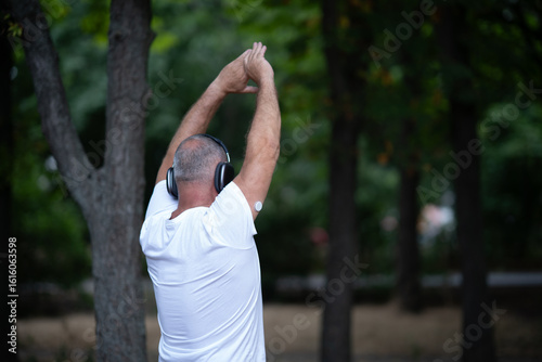 Man Training with Glucose Sensor and Headphones