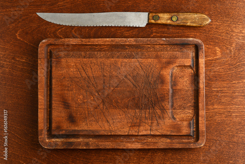 old wood cutting board with knife