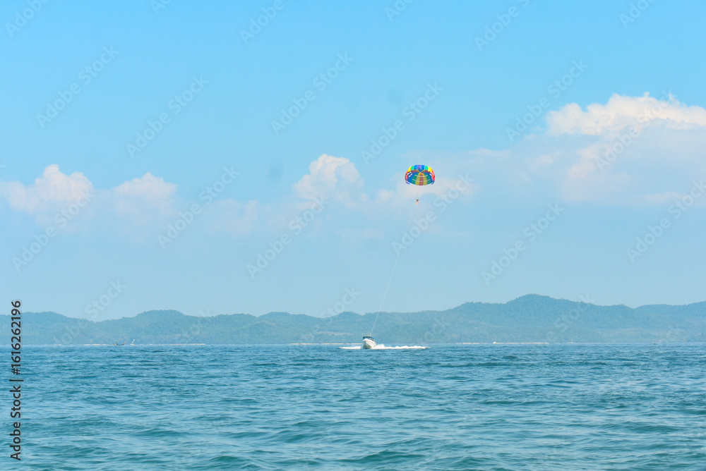 Paragliding above the Andaman sea pulled by a speedboat. Paragliding above the Andaman sea pulled by a speedboat.