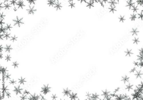 Top-down view of delicate, translucent grey snowflakes with intricate crystalline structures, meticulously scattered on a pristine transparent plain with ample copy space, illuminated by shadowless