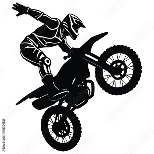 A skilled motocross rider performing a wheelie with his dirt bike, silhouette