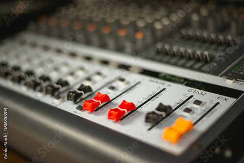 Mixing consoles are devices for creating high-quality sound. control of sound sources at concerts and holidays. Audio channel strips and frequency and volume control sections. High quality photo