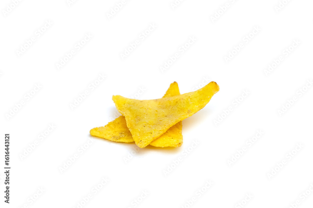Fototapeta premium Yellow tortilla chips stacked on a clean white background, showcasing their crispy texture and triangular shape, perfect for snacking or culinary presentations