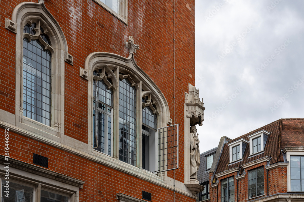 Fototapeta premium A close up of distinctive facades of London residential and business properties in central district within the City of Westminster with ornate windows and architectural details.
