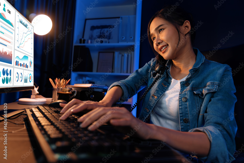 Φωτογραφία Young beautiful Asian creative woman calling on phone to customer or coworker informing strategy marketing creator plan while searching market analysis on pc at neon modern office at night