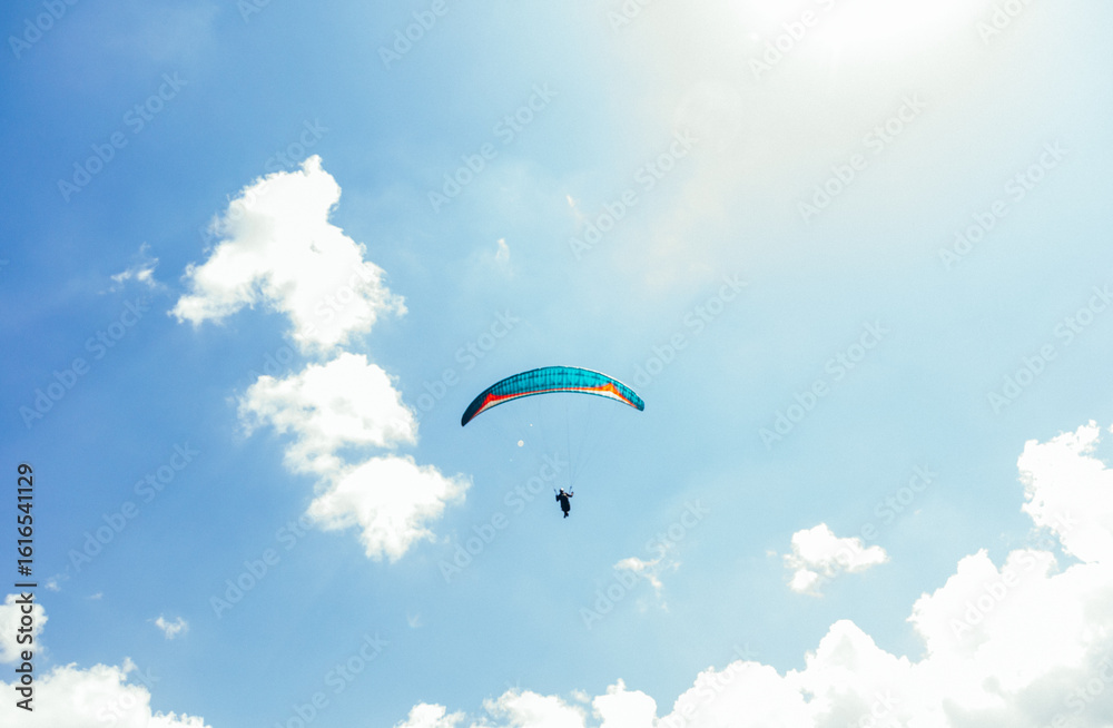 Paragliding against the backdrop of a clear blue sky and mountains.Papraplans in Chegem, Kabardino-Balkaria Paragliding against the backdrop of a clear blue sky and mountains.Papraplans in Chegem, Kabardino-Balkaria