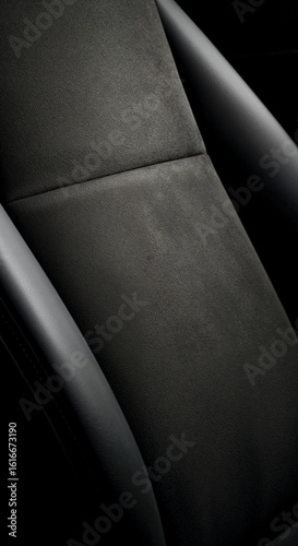 Close-up of luxurious alcantara upholstery highlighting texture and stitching detail.
